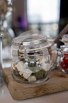 Glass jars with healthy party snacks served in bar, tasty appetisers