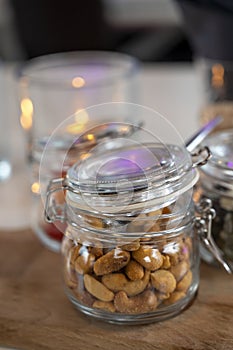 Glass jars with healthy party snacks served in bar, tasty appetisers