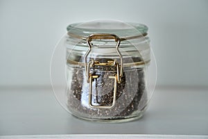 Glass jars with lid for food white shelf. Storage in kitchen. bay leaf. Herbage.