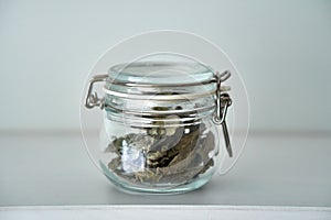 Glass jars with lid for food white shelf. Storage in kitchen. bay leaf. Herbage.