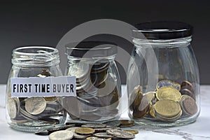 Glass jars with multicurrency coins and text on white torn paper