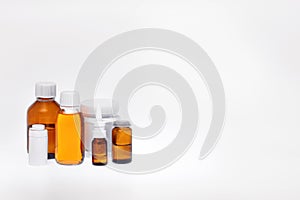 glass jars and plastic containers with medicines on a white background