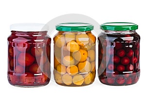 Glass jars with preserved apricots, cherries and plums