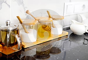 glass jars with salt sugar and honey in. modern kitchen interior