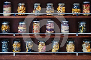 glass jars with various varicoloured types of pasta