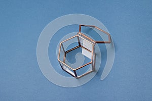 Glass jewellery box on blue background, closeup