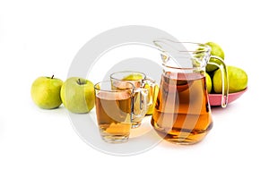 Glass and a jug of apple juice , isolated on white background