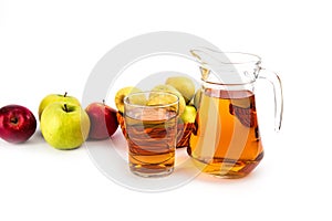 Glass and a jug of apple juice , on white background