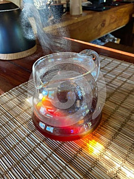 Glass jug fresh coffee water sunlight hot water vapor coffee table in the shop