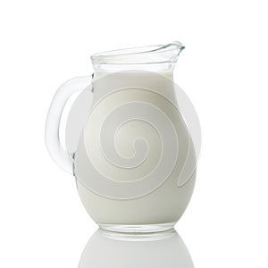 Glass jug of fresh milk isolated on white background