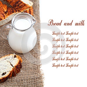 Glass jug with milk and bread