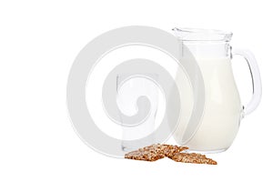 Glass jug with milk isolated on a white background