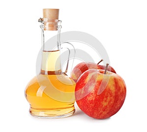 Glass jug of vinegar and fresh apples