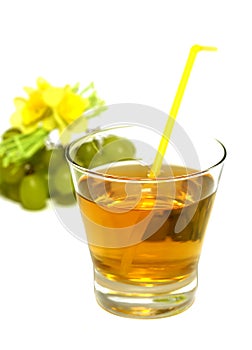 glass of juice and grapes isolated on white