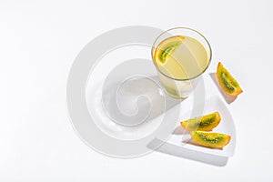 glass with juice and slices of lulo fruit, on the table