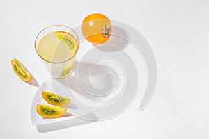 glass with juice and slices of lulo fruit, on the table