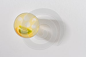 glass with juice and slices of lulo fruit, on the table