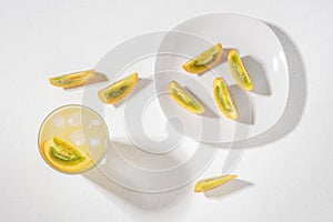 glass with juice and slices of lulo fruit, on the table