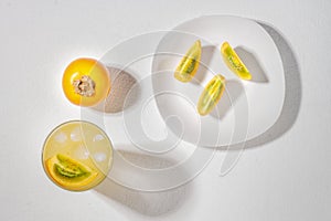 glass with juice and slices of lulo fruit, on the table