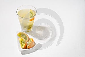 glass with juice and slices of lulo fruit, on the table