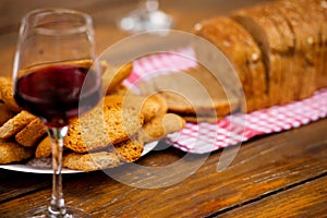Glass of juice and toasted bread on wooden table