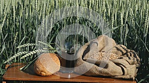 A glass of kvass and bread in a wheat field