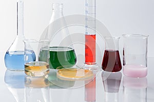 Glass laboratory apparatus with color water on the table