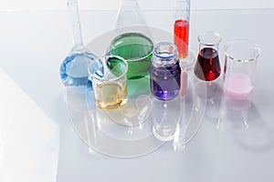 Glass laboratory apparatus with color water on the table