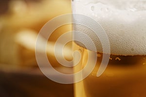 Glass of lager beer closeup on wooden table