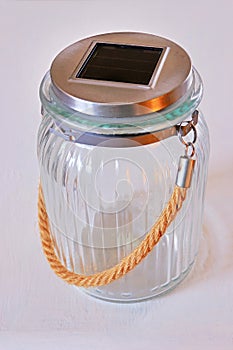 Glass latern jar with solar panel. Solar energy home decoration
