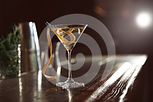 Glass of lemon drop martini cocktail on bar counter.
