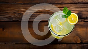 Refreshing Lemonade With Lemon Slices And Mint On Wooden Table photo
