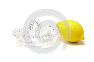 Glass lemon squeezer and lemon isolated on a white background