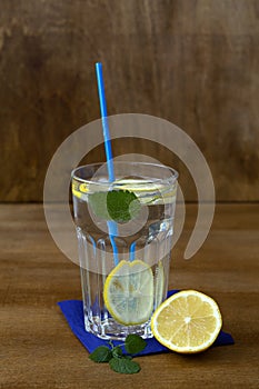 Glass of lemonade with lemon and fresh leafs mint. homemade cold refreshing drink
