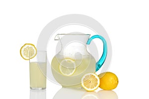 Glass of lemonade with pitcher