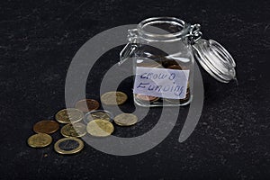Glass with letters crowd funding and coins