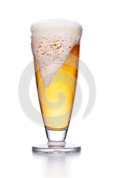 glass of light beer foam. lager beer in a glass beaker with fresh bubbling foam isolate.