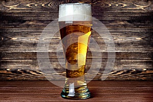 Glass of light beer on a pub with bokeh background