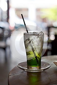 Glass of Lime Soda with ice cubes on a cafe table