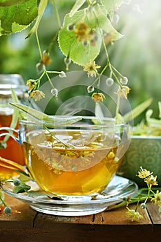 A glass of linden tea with lemon and honey