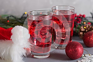 Glass of mango dragonfruit refresher drink on table with ice cubes. Copy space