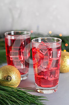 Glass of mango dragonfruit refresher drink on table with ice cubes. Copy space