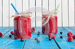 Glass mason jar with raspberry jam and fresh