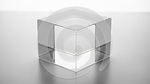 The glass material emphasizes the geometric simplicity and elegance of the cube