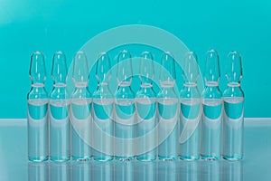 Glass medical ampoule vial for injection. Medicine is liquid sodium chloride with of aqueous solution in ampulla. Close