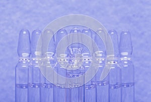 Glass medical ampoule vial for injection. Medicine is liquid sodium chloride with of aqueous solution in ampulla. Close
