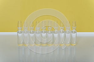 Glass medical ampoule vial for injection. Medicine is liquid sodium chloride with of aqueous solution in ampulla. Close