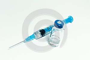 Glass medicine bottle with vaccine injection fluid with aluminium cap and syringe for vaccination, Coronavirus Covid-19 concept