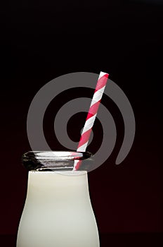 Glass of milk on black background