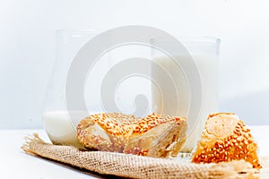 A glass of milk with bread and grains